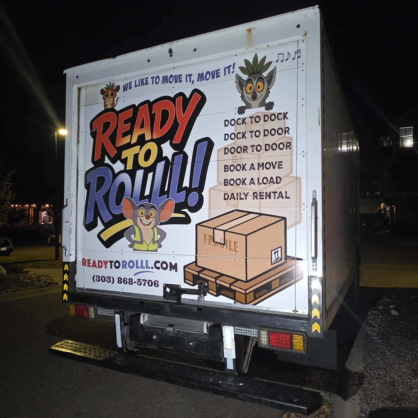 The back of the Ready to Rolll! box truck at night, showing the full wrap